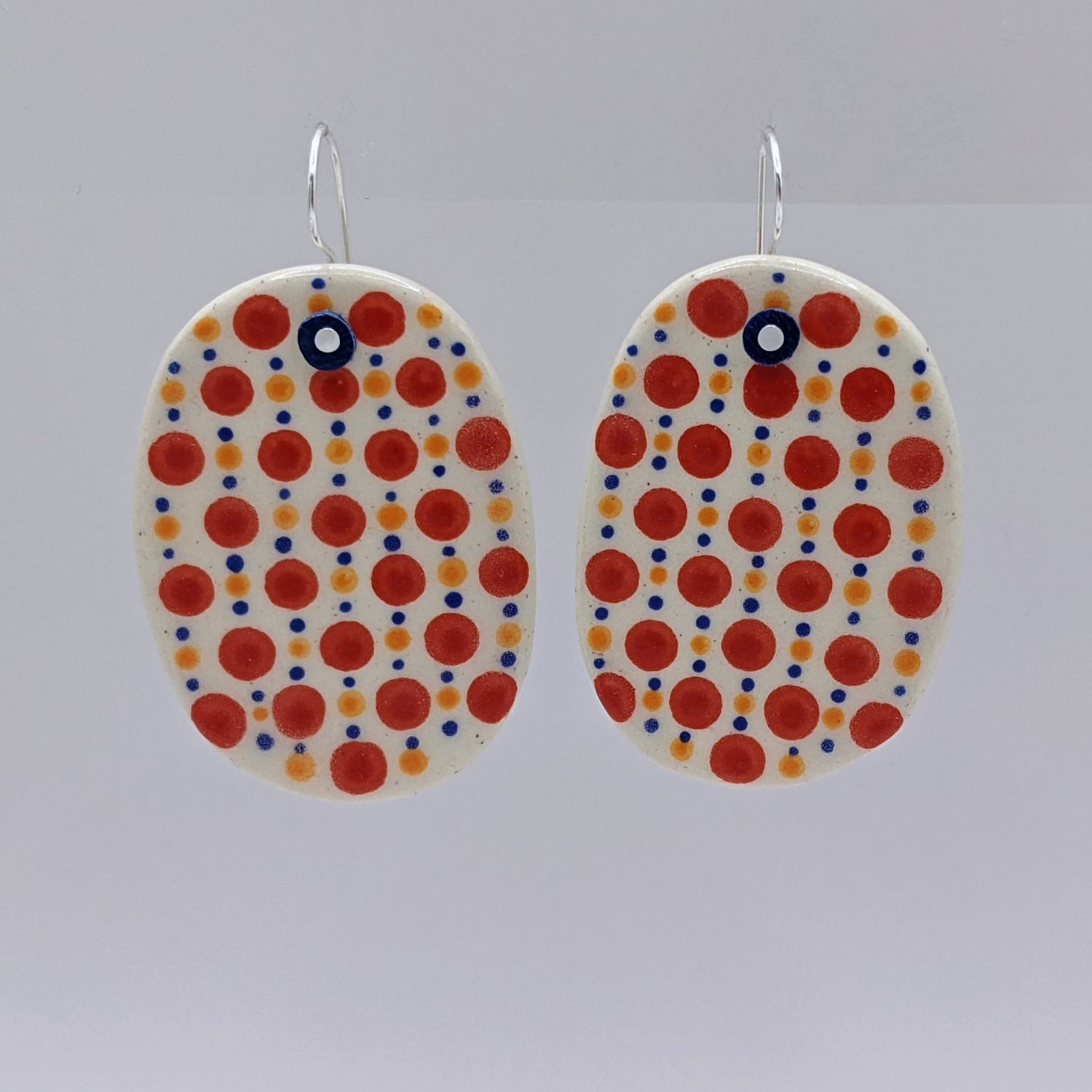Here and Here: Red Dotted Ceramic Disc Earrings Product Image 1 of 3
