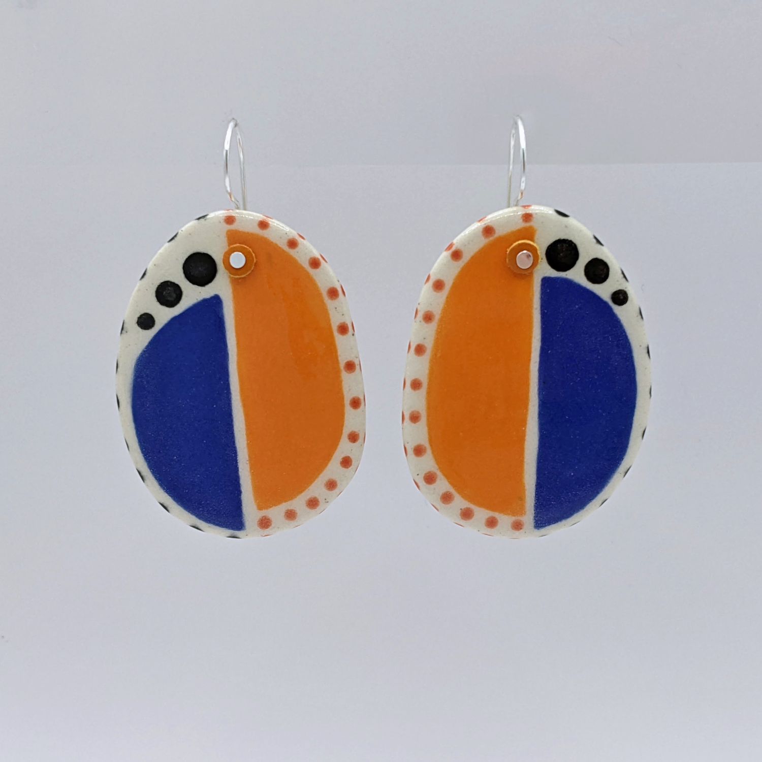 Here and Here: Half Blue and Half Orange Ceramic Disc Earrings Product Image 2 of 4