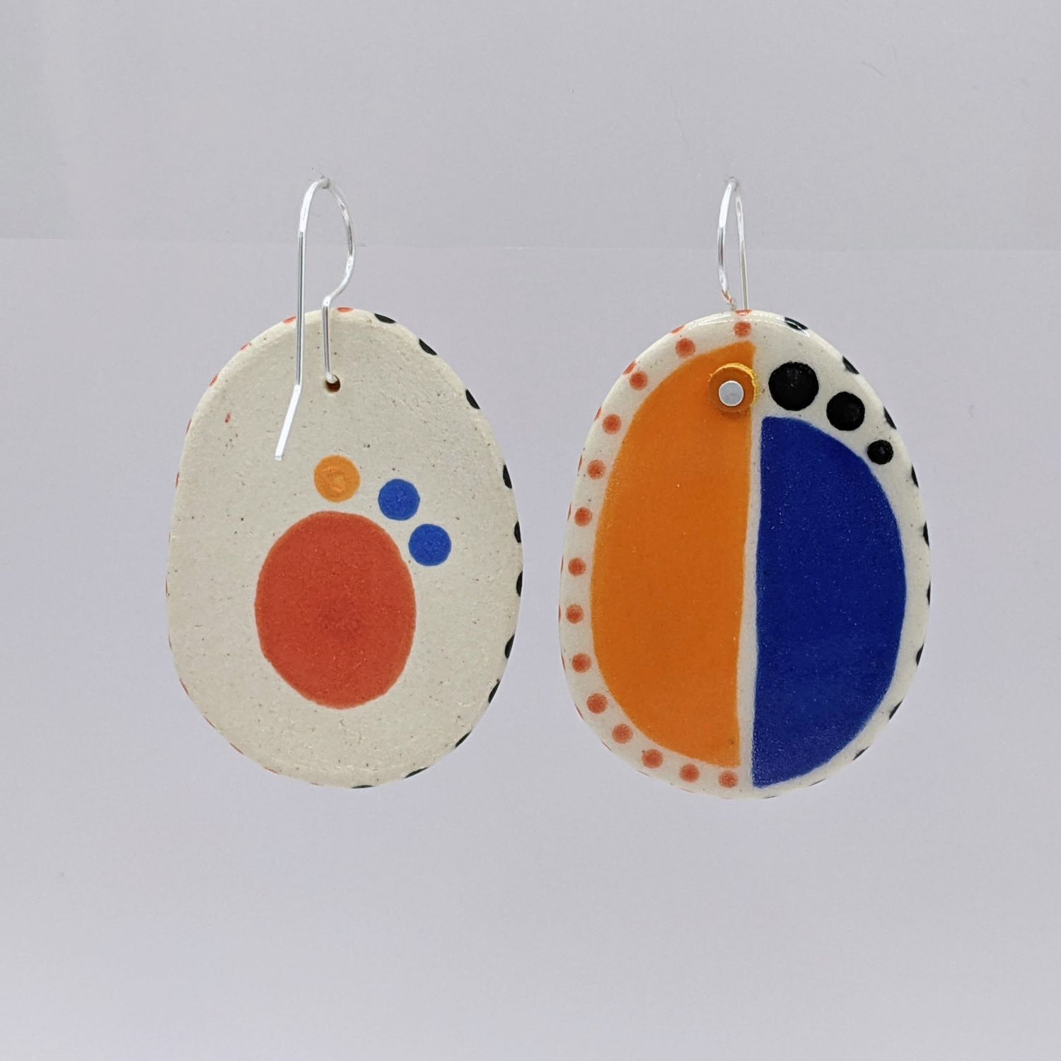 Here and Here: Half Blue and Half Orange Ceramic Disc Earrings Product Image 3 of 4