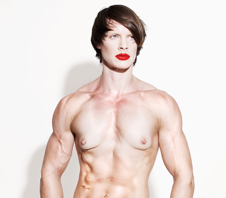 Artist Cassils posed in a jockstrap with red lipstick