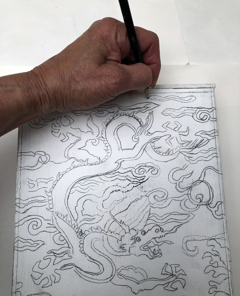 Hand drawing clouds and waves around a dragon