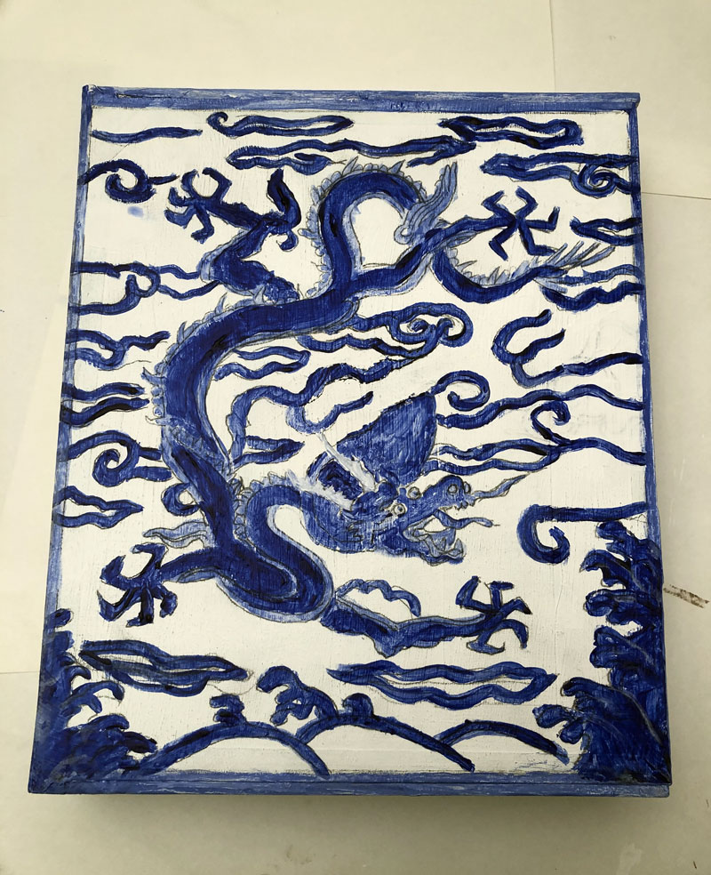 Blue design of a dragon with borders on a white box