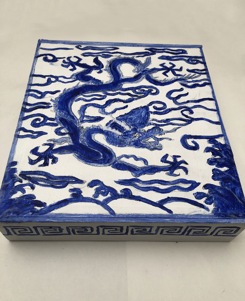Blue-and-white cardboard painted box with a dragon