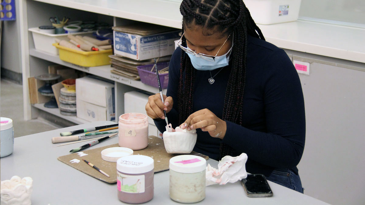 Person in the studio glazing