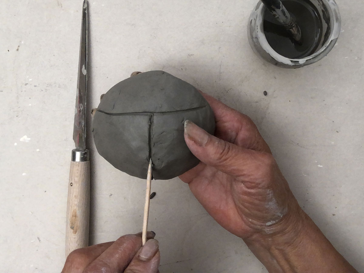Drawing lines on a clay ball