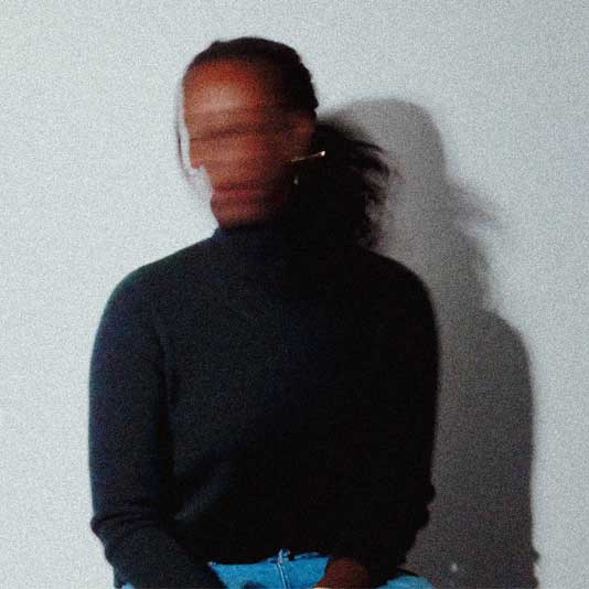 Artist Chiedza Pasipanodya seen in a blurry image wearing a black sweater