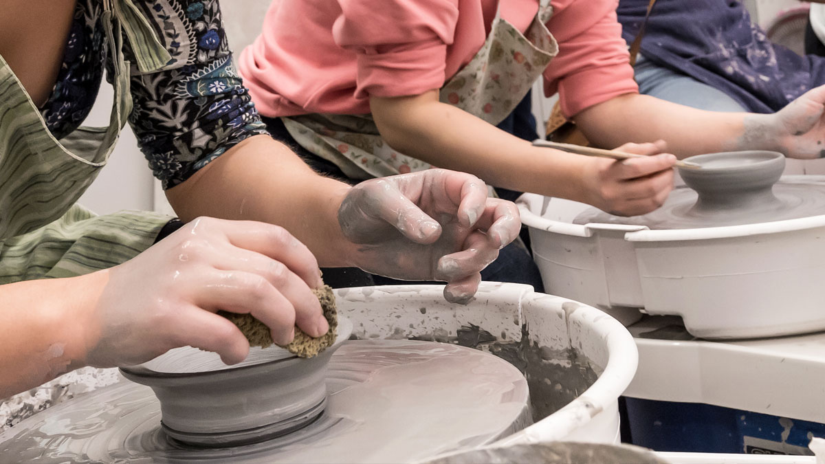 Students using the pottery wheel