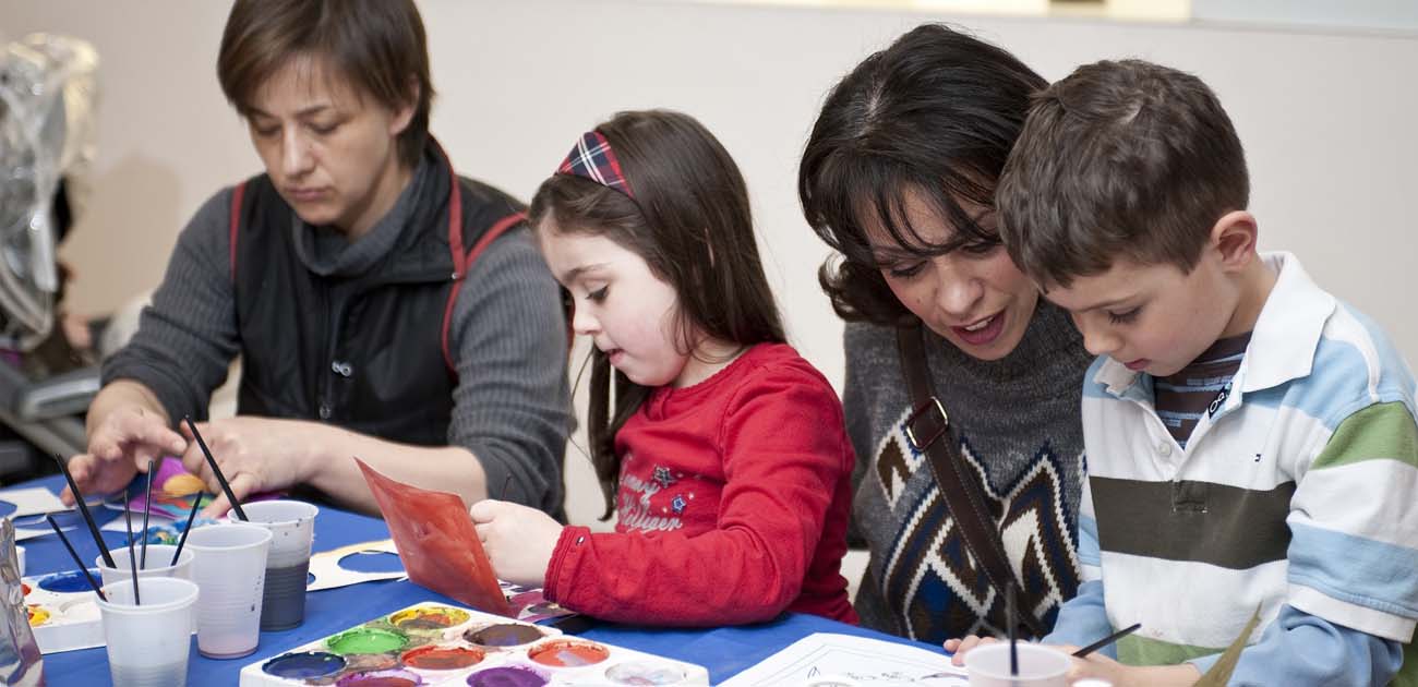 A family participating in an arts and craft activity