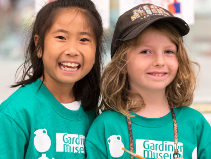 Two young girls smiling and wearing Gardiner Museum t-shirts