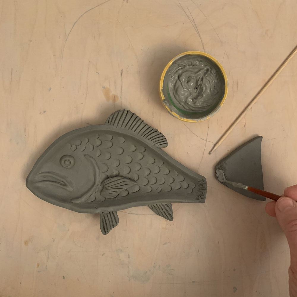 Attaching a tail to a clay fish