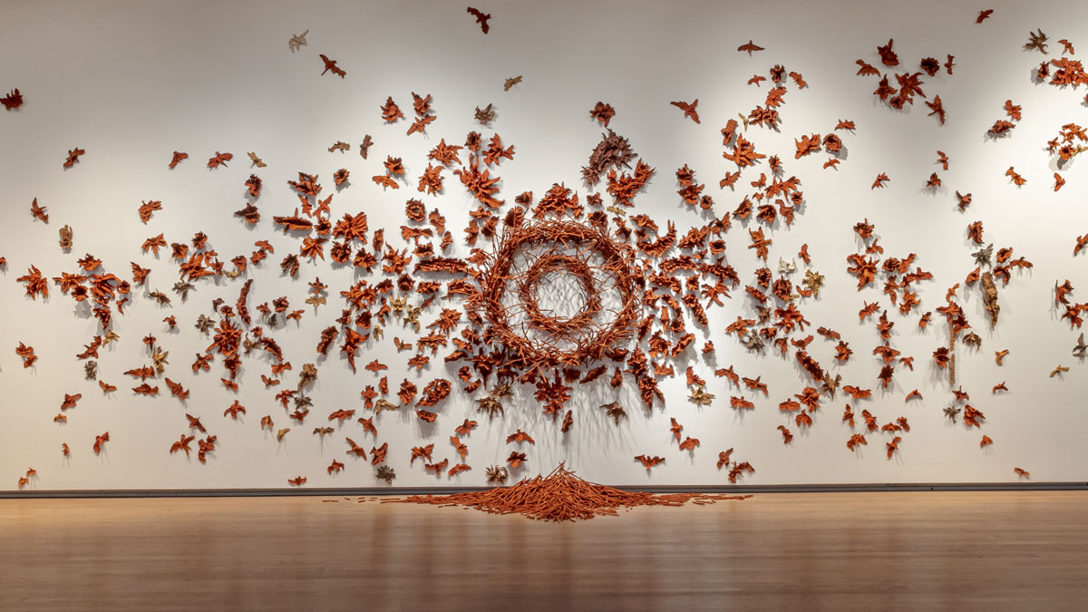 Installation of clay birds on a wall