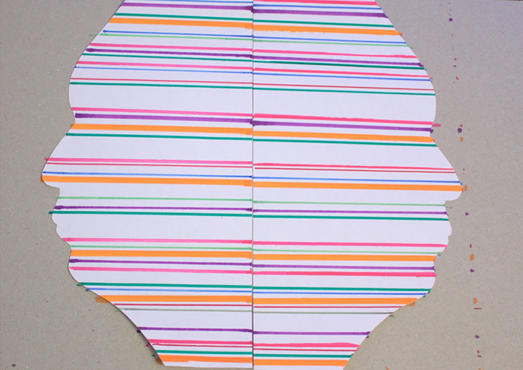 Two paper silhouettes with colourful stripes