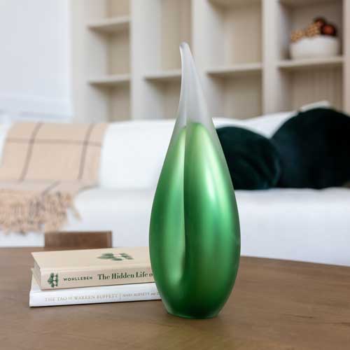 Green glass sculpture in the shape of a flame