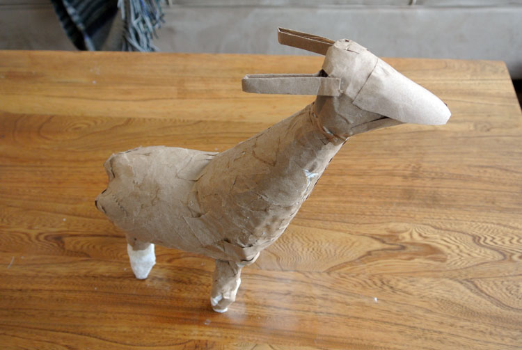 Llama-like figure covered in brown paper strips