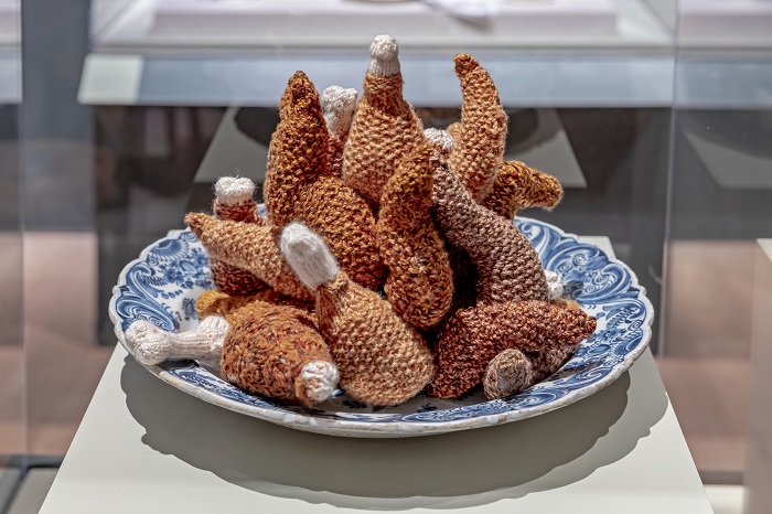 Knitted chicken wings and legs on a ceramic plate 
