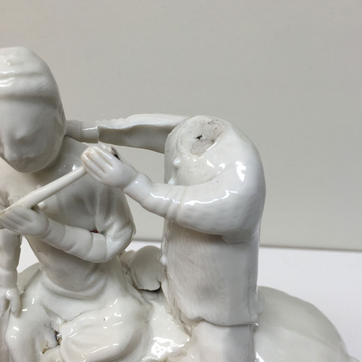 Two porcelain figures, one is missing a head