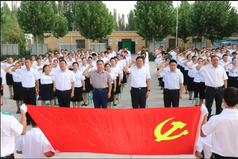 © State WeChat account | Caption: Village officials swear allegiance to the Chinese Communist Party in Kashgar, Xinjiang.