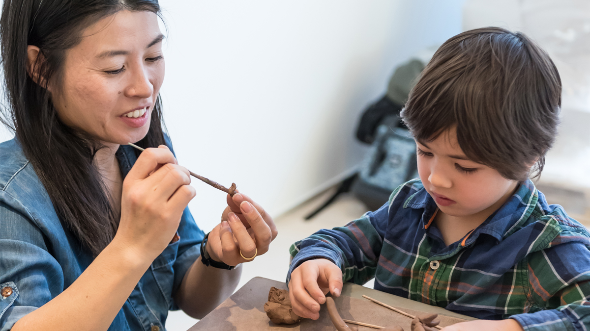 Family Day at the Gardiner Museum. A parent and child work in a clay sculpture