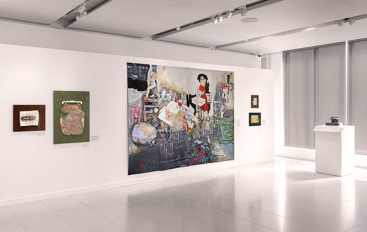 Installation view of a large painting with wall hung ceramic sculptures around it