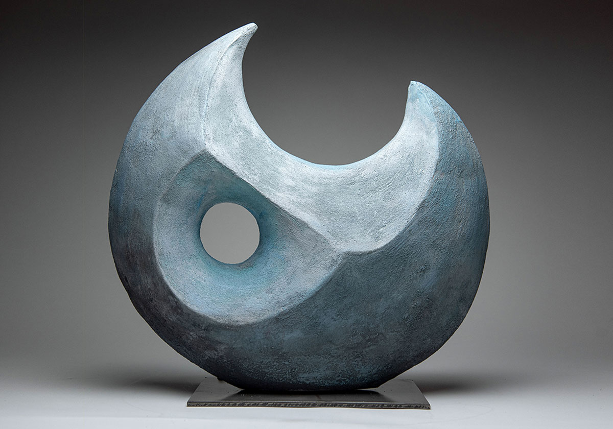 A ceramic sculpture in the form of a crescent moon