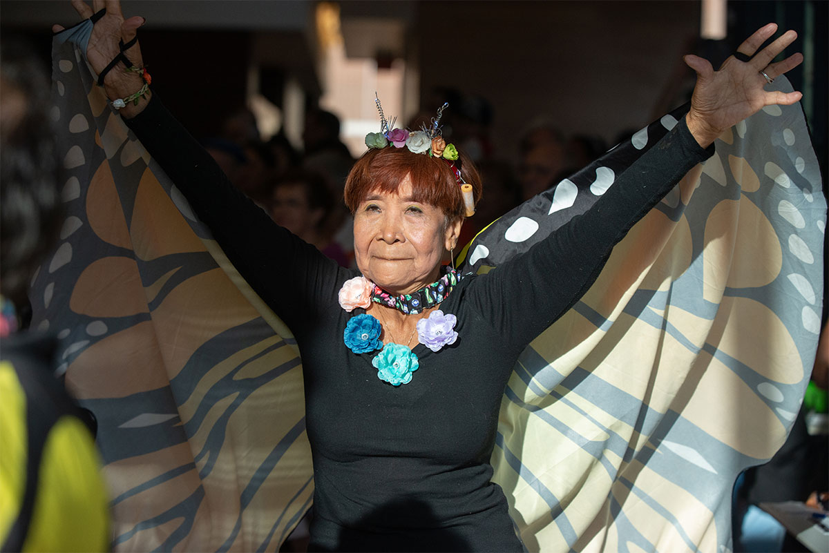 An older woman dressed as a butterfly