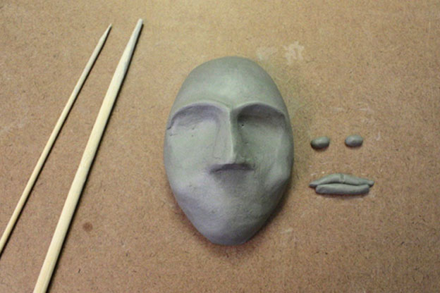 Clay face with eyes and lips to stick on