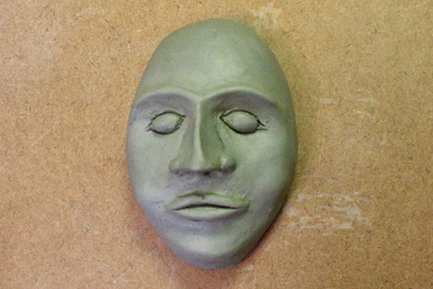 Ceramic face with eyes, nose, and lips