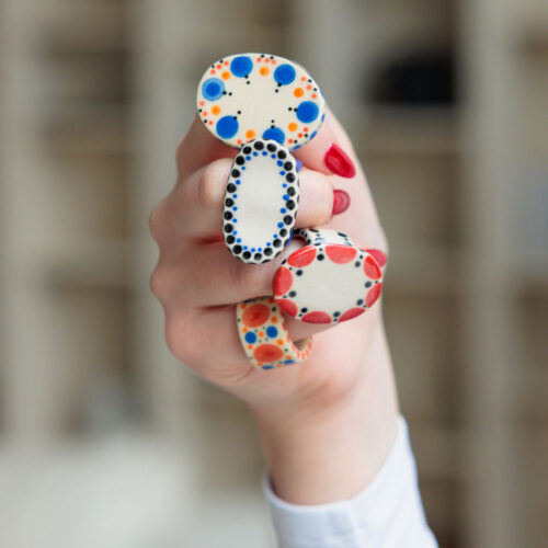 A hand with ceramic rings on each finger