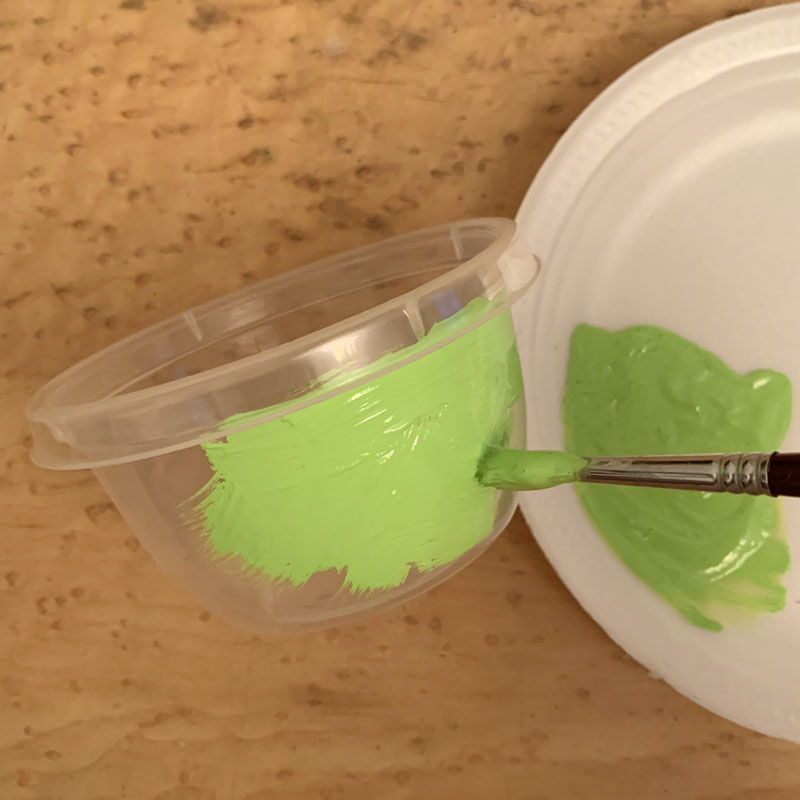 Plastic container being painted green
