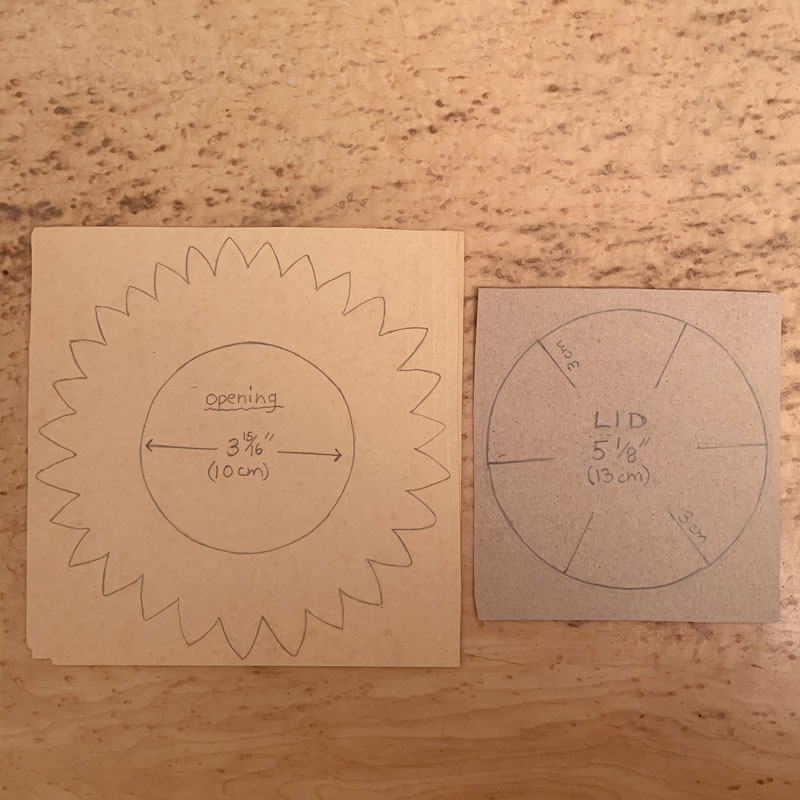 Two pieces of paper with the outlines of sunflowers drawn on them