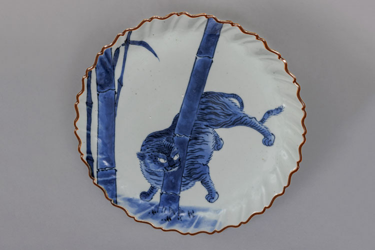 White porcelain plate with a blue tiger and bamboo