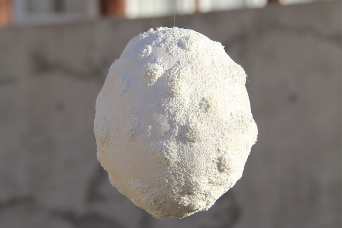 White ceramic sphere with textured surface