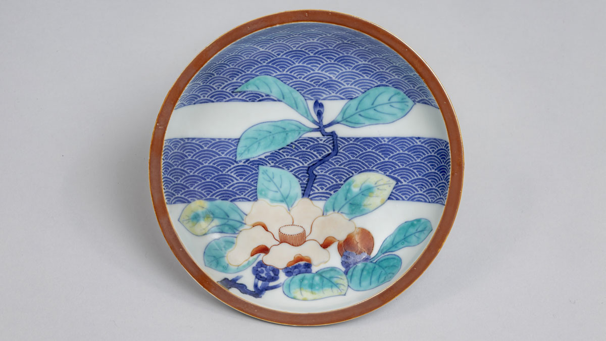 Nabeshima porcelain plate with blue, red, green, and yellow foliage design