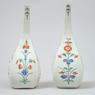 Pair of Hizen bottles of tapering square form decorated in the Kakiemon palette with iron-red, blue, green and black enamels