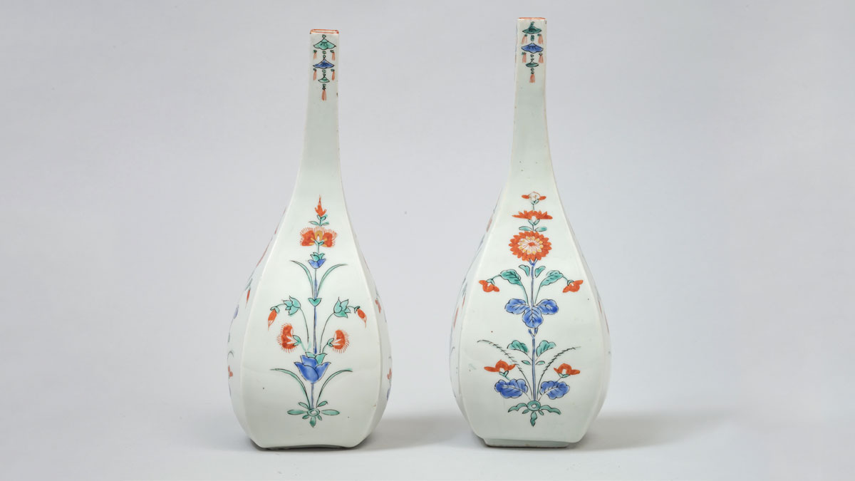 Pair of Hizen bottles of tapering square form decorated in the Kakiemon palette with iron-red, blue, green and black enamels