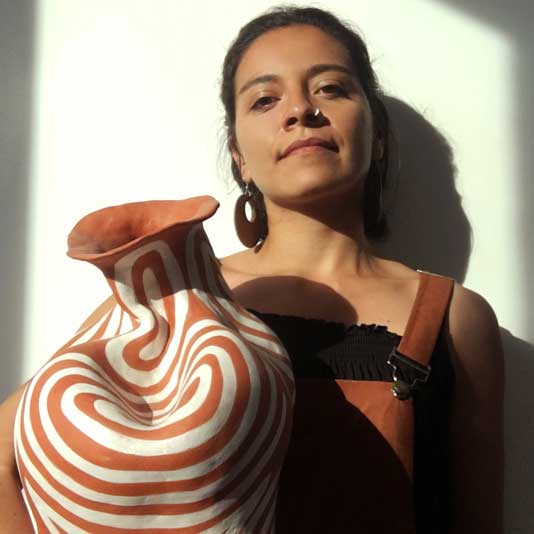 Mariana Bolaños Inclán holding a ceramic vessel