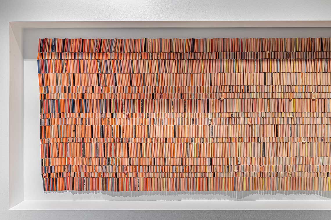 An installation of clay beads in the colours of a sunset