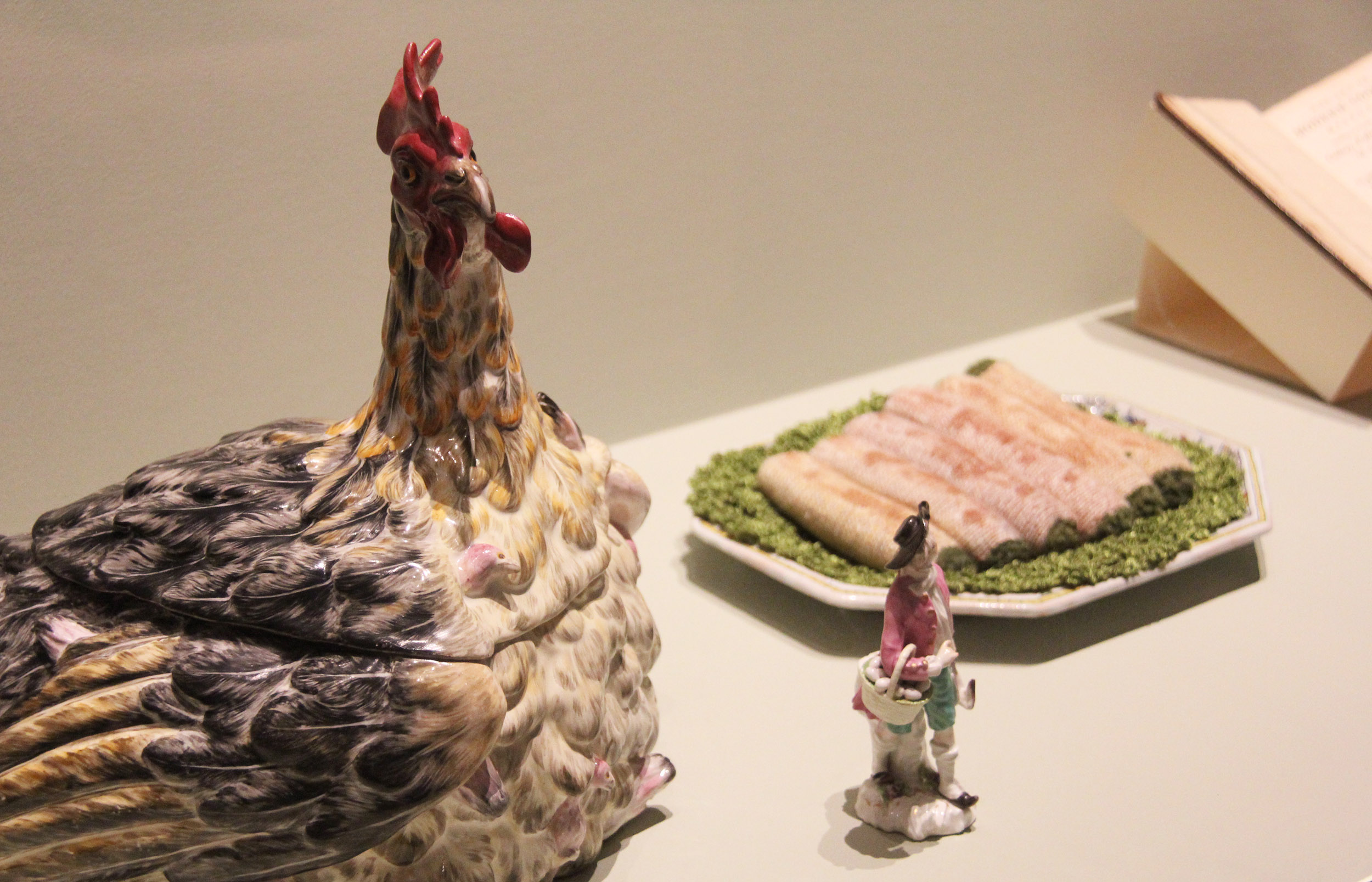 Rooster tureen, porcelain figurine holding a basket, and knitted omelettes
