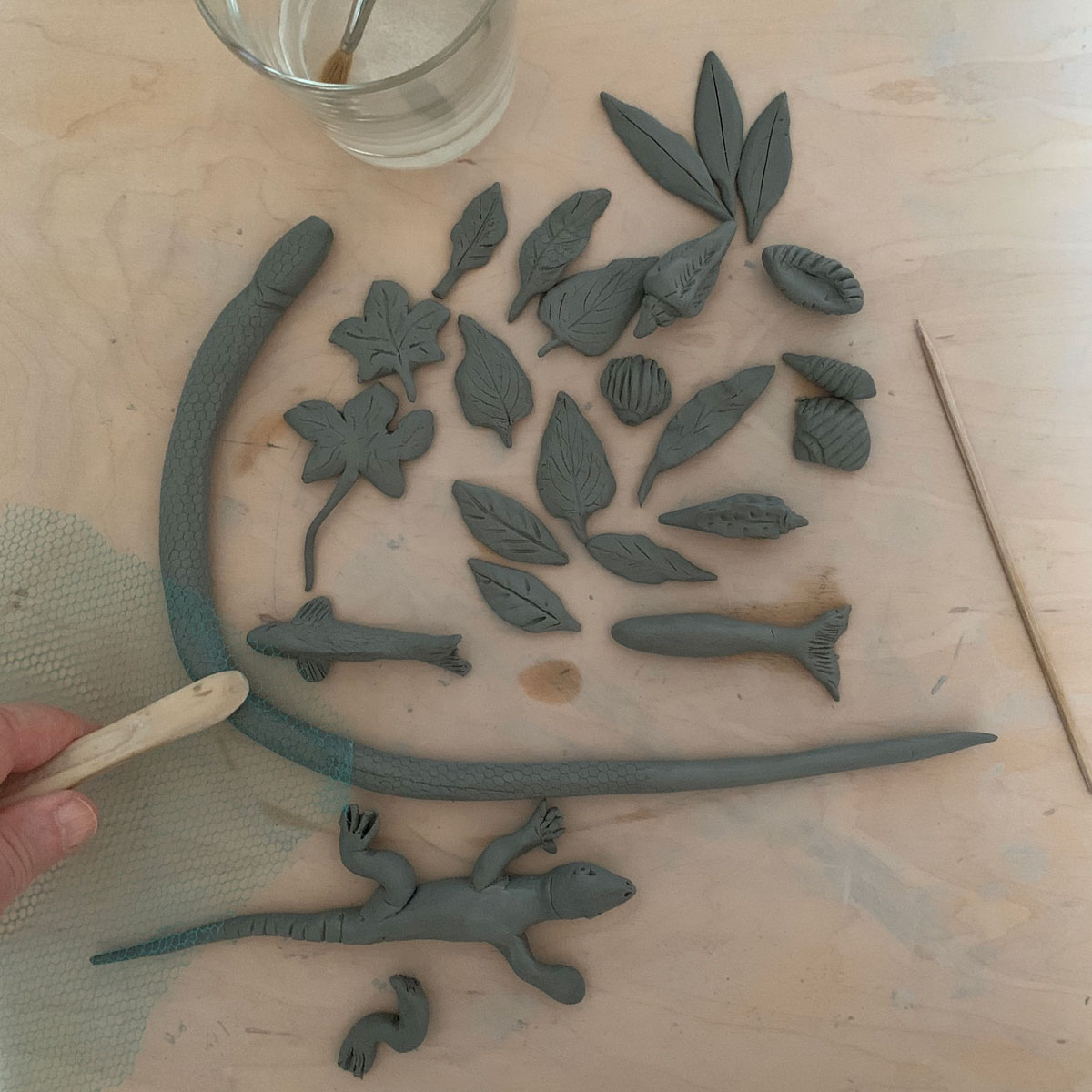 Clay leaves, a lizard, and other creatures