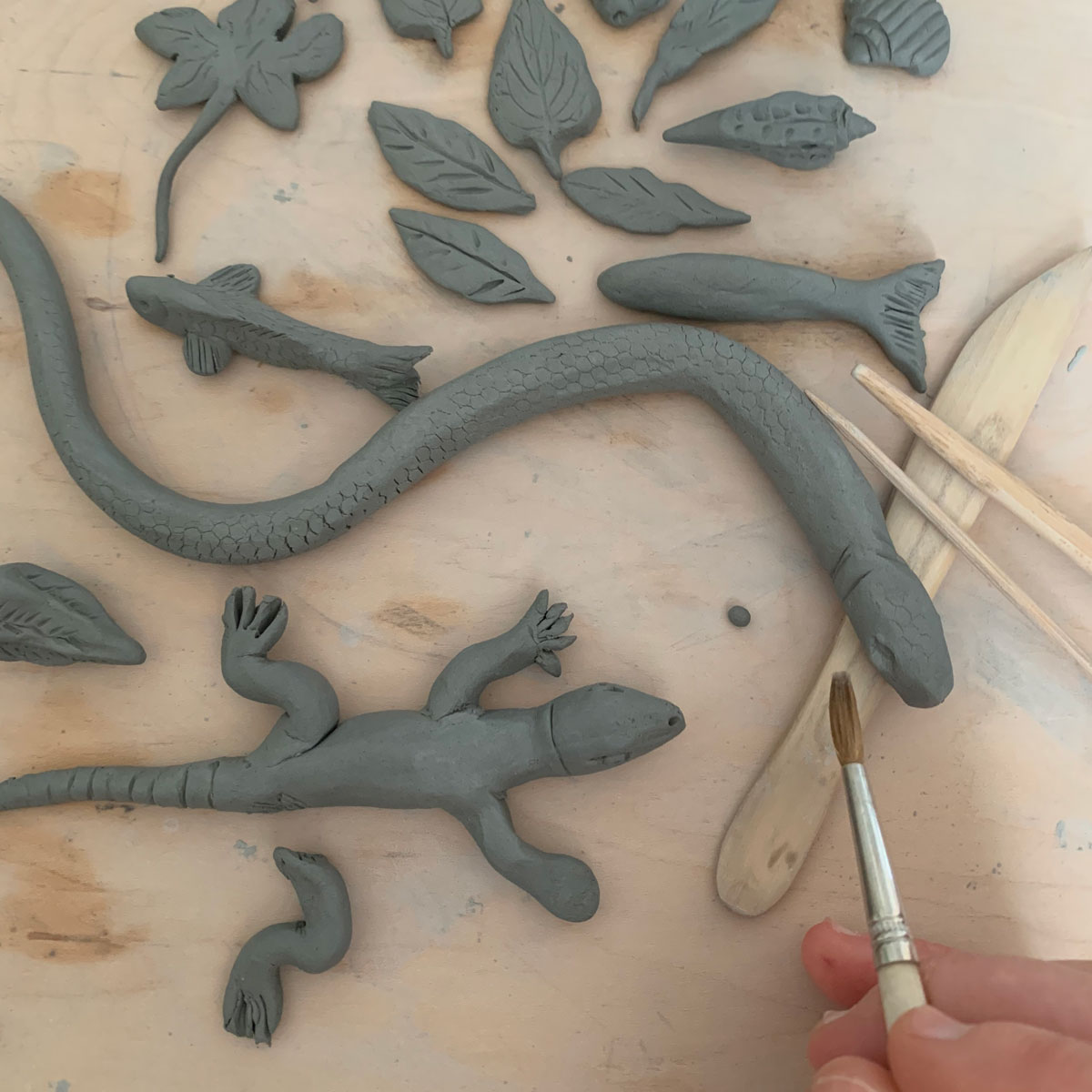 Clay snake, lizard, a leaves