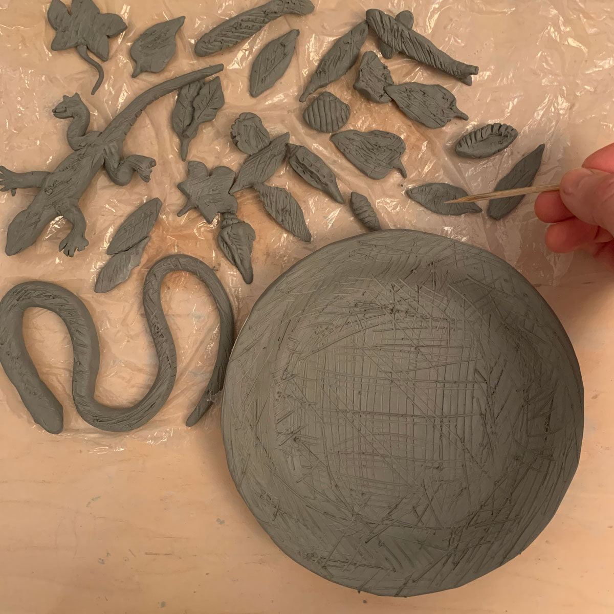 Clay plate and creatures with scratch marks