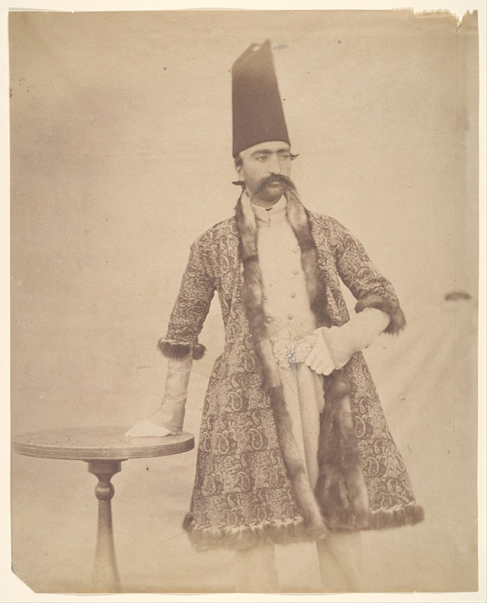 An old photo of Naser al-Din Shah wearing a robe and tall hat