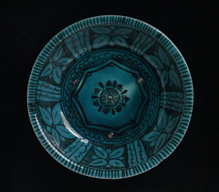 A black and turquoise dish from Iran