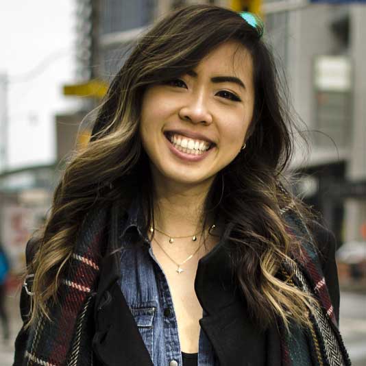 A Chinese woman with long hair smiling at the camera