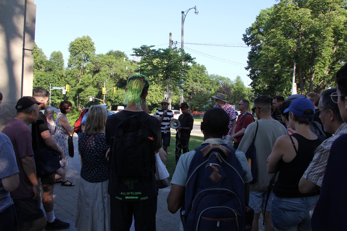 People participating in a walking tour of Queen's Park