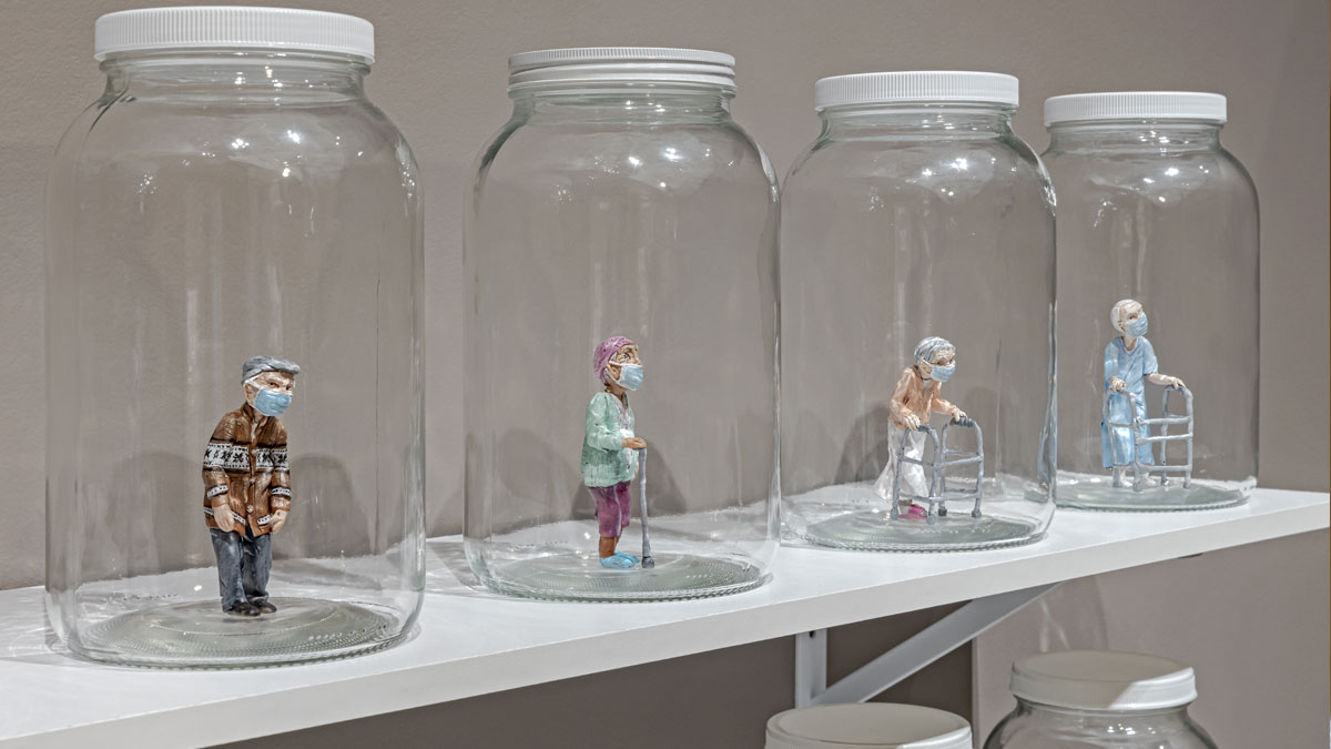 Miniature clay figures of elderly individuals in jars