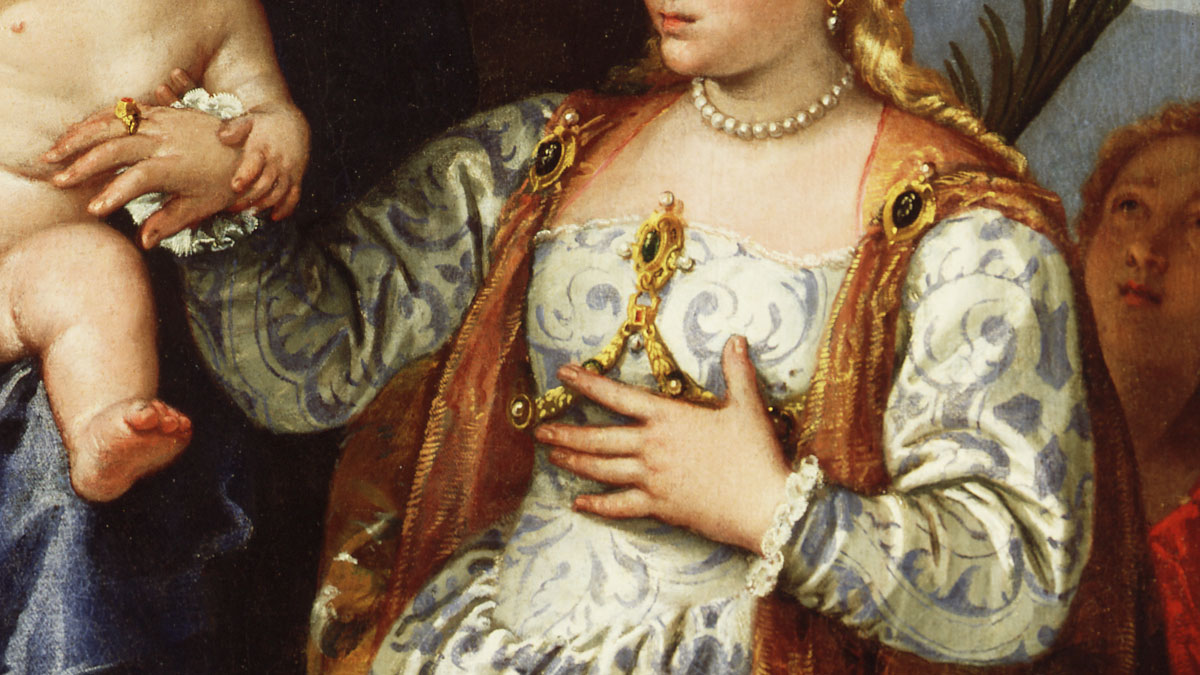 Detail of a Renaissance painting featuring a woman wearing on ornate dress and jewellery