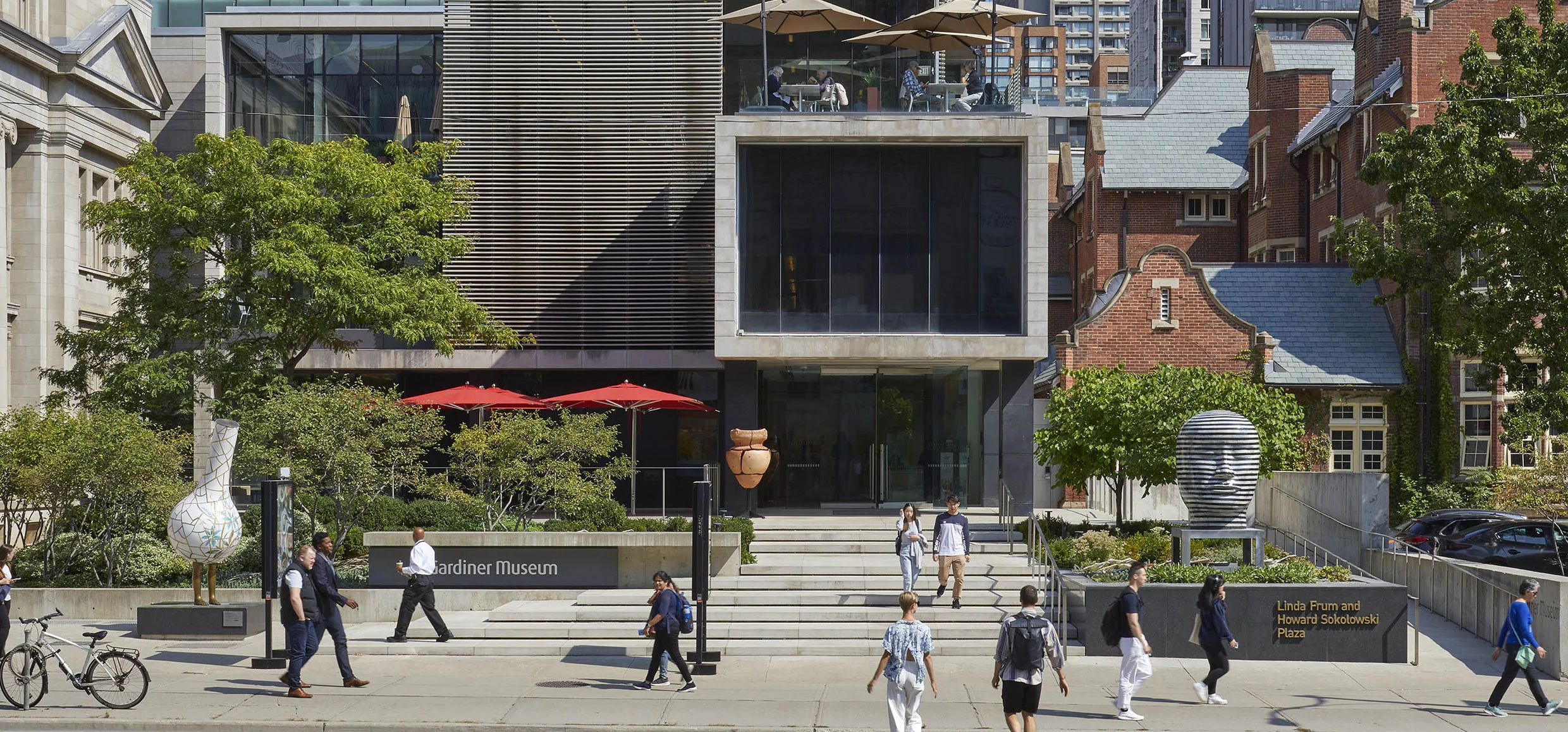 Exterior of the Gardiner Museum with people walking in front of the building