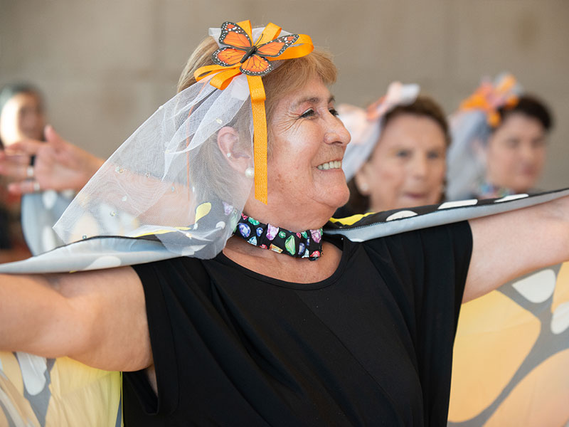 An older woman dressed as a butterfly