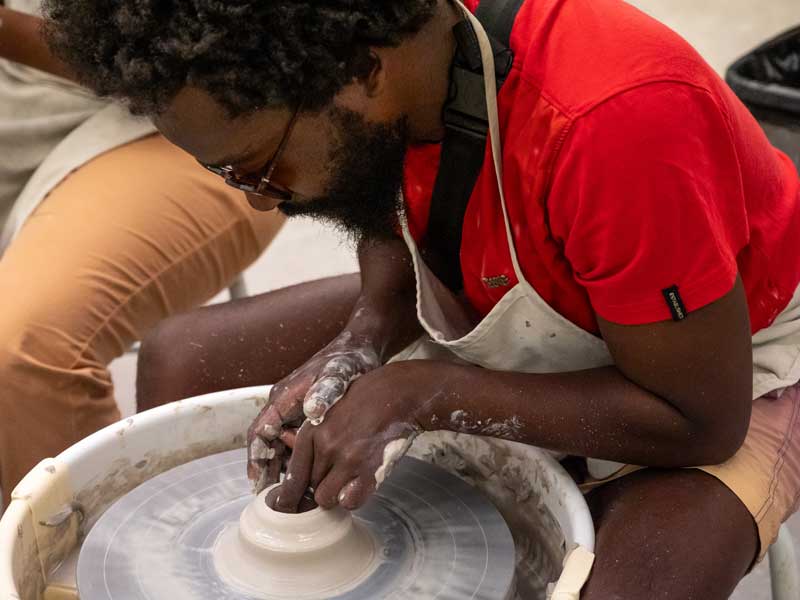 A man using the pottery wheel